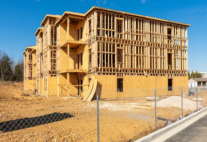 a temporary chain link fence winding around a job site, outlining the project's progress in Carlsbad, NM